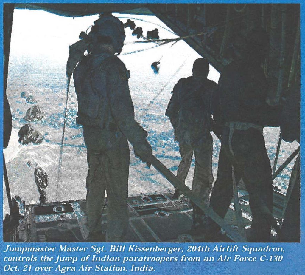 Jumpmaster Master Sgt. Bill Kissenberger, 204th Airlift Squadron, controls the jump of Indian partroopers from an Air Force C-130 Oct. 21 over Agra Air station
