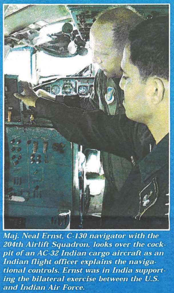 Maj. Neal Ernst, C-130 navigator with the 204th Airlift Squadron, looks over the cockpit of an AC-32 Indian cargo aircraft as an Indian flight officer explains the navigational controls. Ernst was in India supporting the bilateral exercise between the U.S. and Indian Air Force