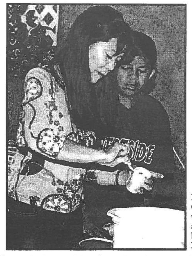 RECYCLING - Gail Miyagi, wife of Brig Gen. Vern T. Miyagi, took the time to teach the youths how to recycle and create beautiful pendants and make a simple but delicious snack