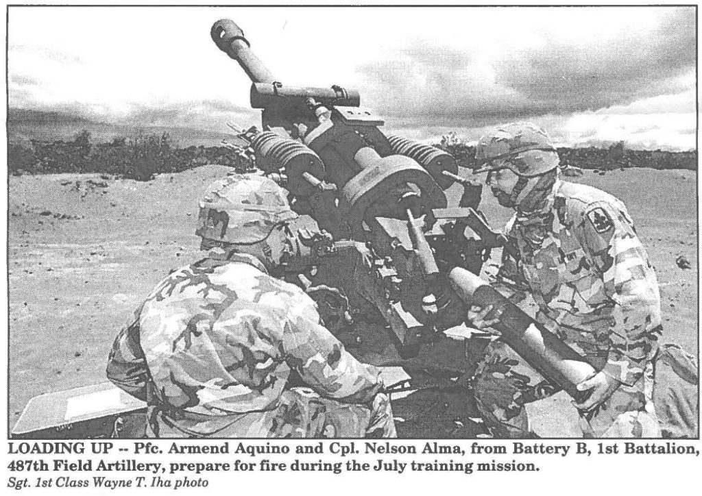 LOADING UP -- Pfc. Armend Aquino and Cpl. Nelson Alma, from Battery B, 1st Battalion, 487th Field Artillery, prepare for fire during the July training mission. Sgt. 1st Class Wayne T. Iha photo