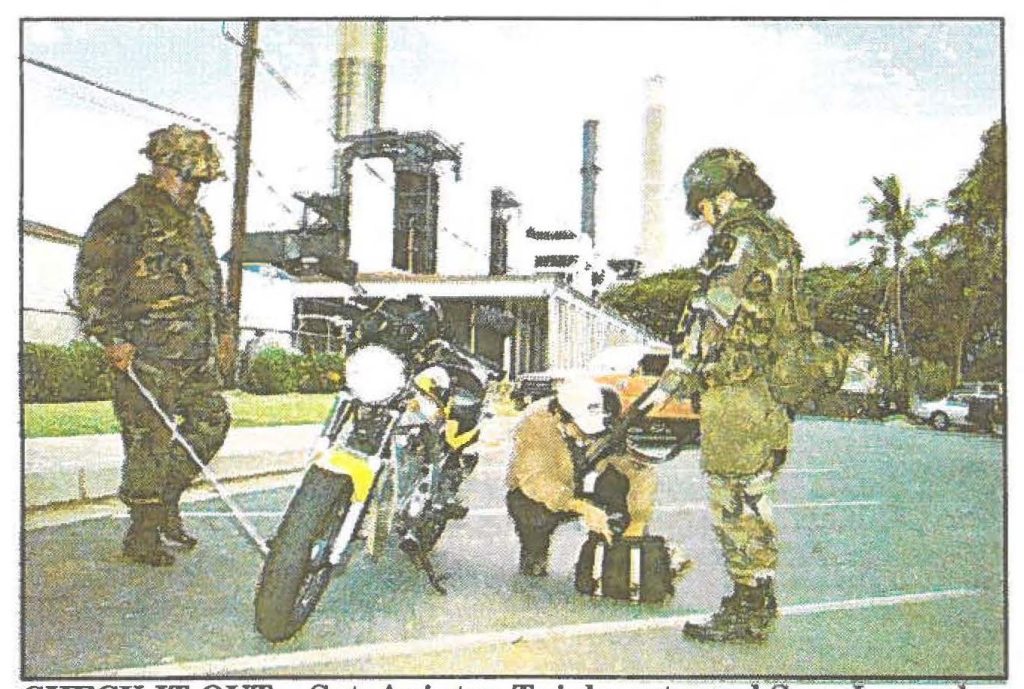 CHECK-IT-OUT .. Sgt. Aniutea Tuiolemoto and Spc. Jacquelyn Corderio inspect a motorbike and bag belonging to a photographer covering the Hawaiian Electric Company's Kahe Point power plant.