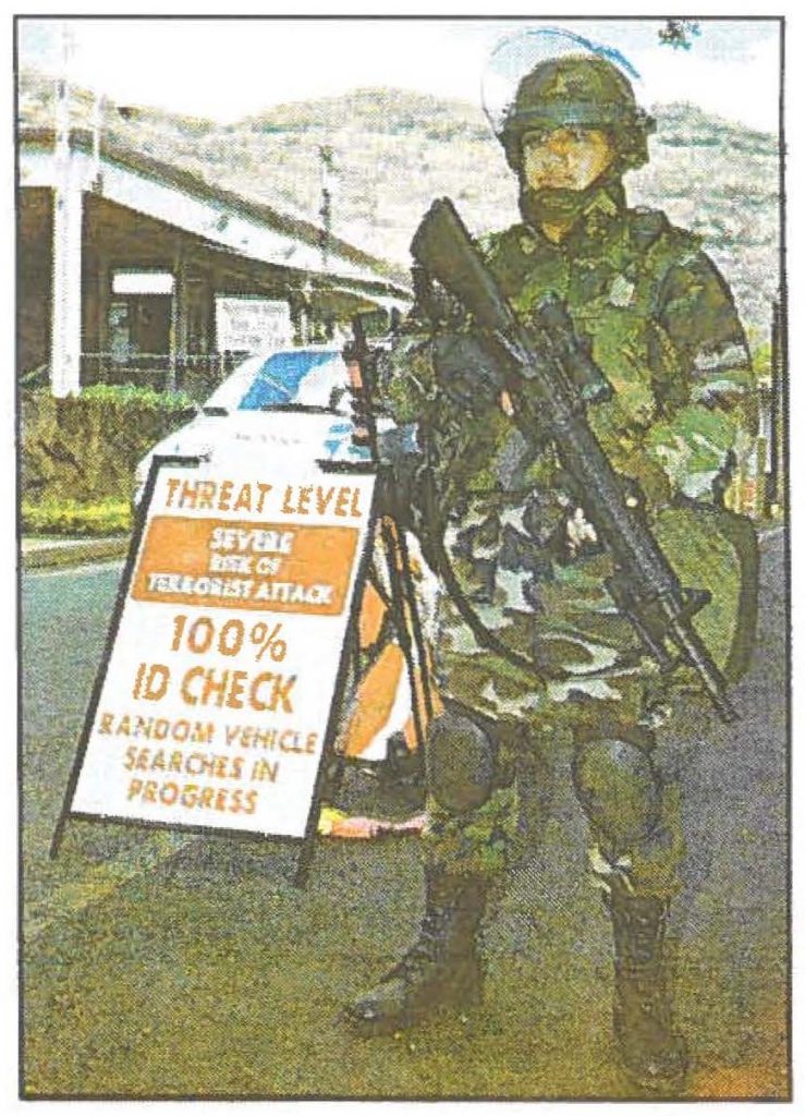 CHECK-IT-OUT .. Spc. Chester Desiderio stands guard at the front gate. The Hawaii Army National Guard's 29th Support Battalion soldiers are part of the rapid response forces.