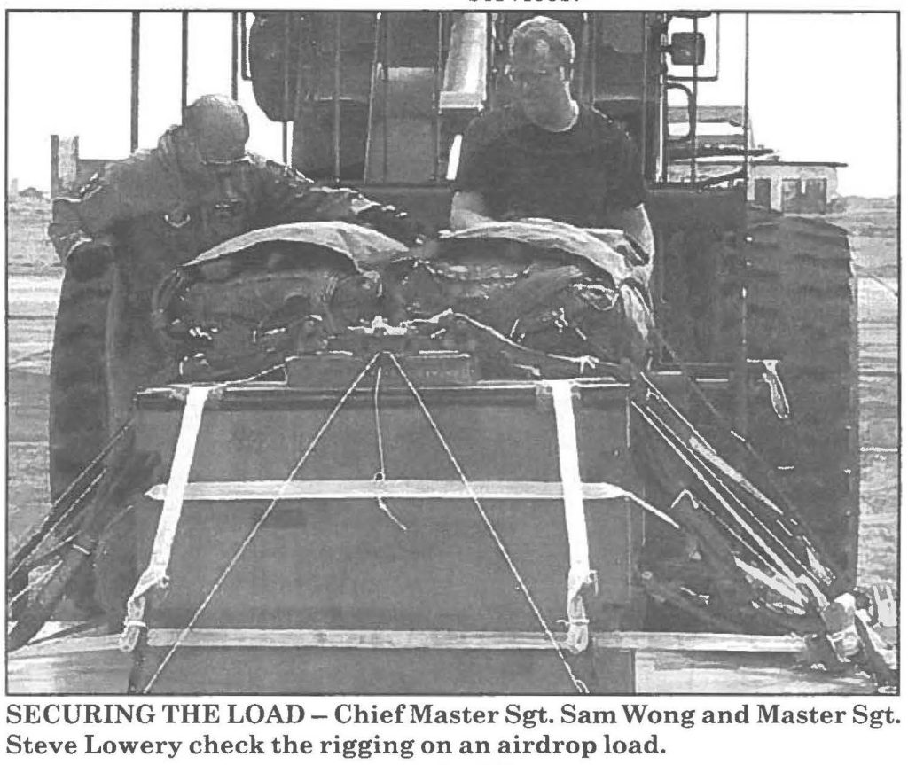 SECURING THE LOAD - Chief Master Sgt. Sam Wong and Master Sgt. Steve Lowery check the rigging on an airdrop load.