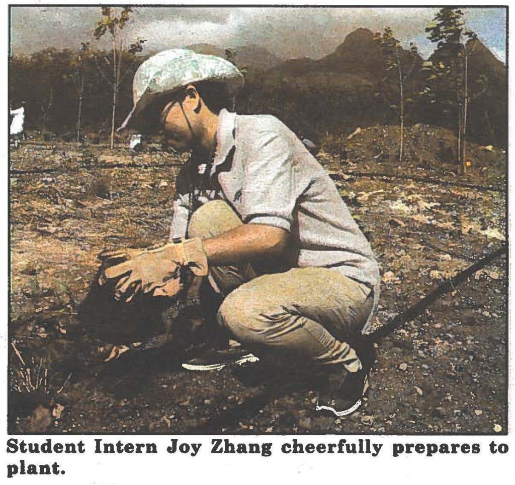 Student Intern Joy Zhang cheerfully prepares to plant.