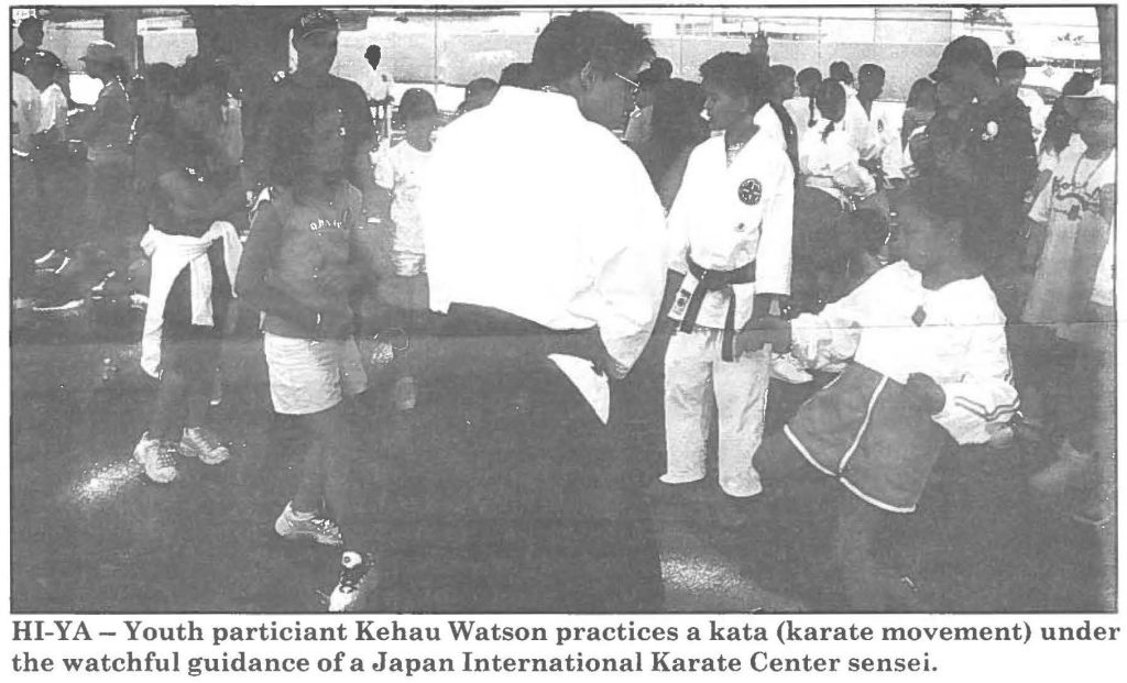 HI-YA- Youth participant Kehau Watson practices a kata (karate movement) under the watchful guidance of a Japan International Karate Center sensei.