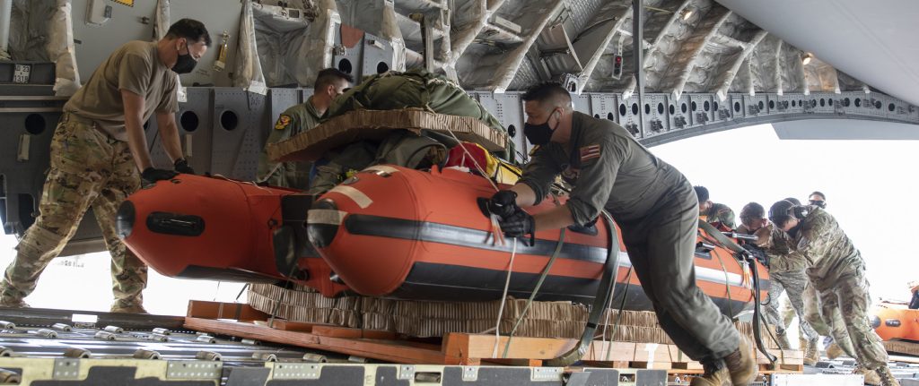 Airmen from various Team Hickam units load pararescuemen equipment onto a C-17 Globemaster III, May 26, 2020 at Joint Base Pearl Harbor-Hickam. The Team Hickam Airmen pre-rigged the C-17 in order to be able to quickly respond to astronaut rescue in the Pacific region in support of a manned space flight launch on May 30. (U.S. Air National Guard photo by Senior Airman Orlando Corpuz)