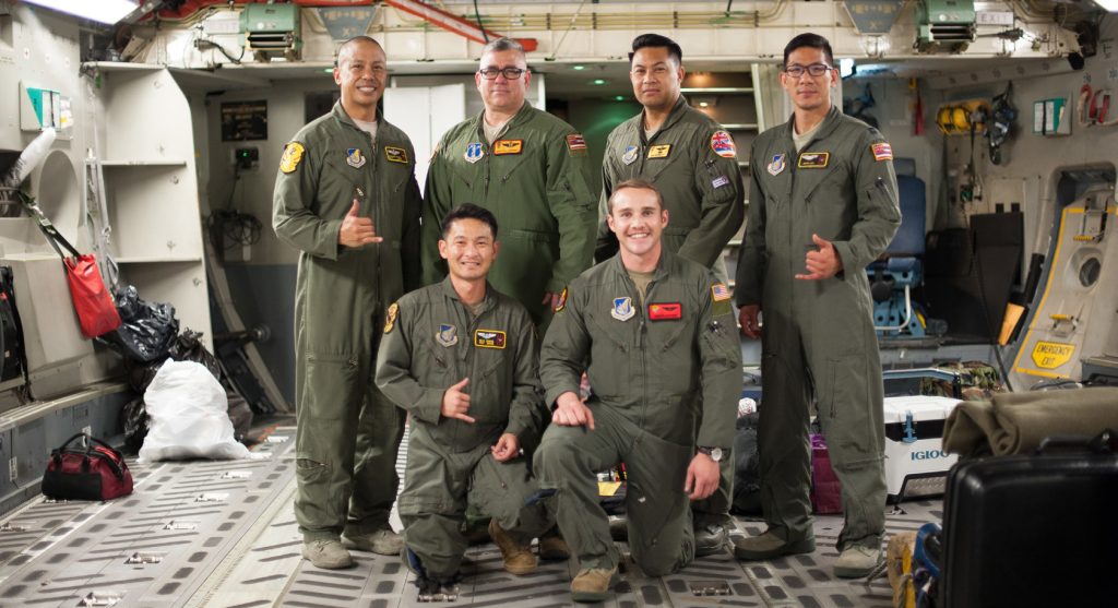 204th Airlift Squadron Airmen, Master Sgt. Brandon Sarceda, Senior Master Sgt. Kale Barney, Maj. Kalei Ho’opai, Capt. Justin Sato, Tech. Sgt. Sean Chang, and a member of the 535th AS, 1st Lt. Andrew Lightsinn, celebrate their arrival at Joint Base Pearl Harbor-Hickam, Hawaii, March 31, after completing a 41-hour aeromedical-evacuation mission. The crew transported prematurely born twins from Osan Air Base, Republic of Korea, to Joint Base Andrews, Maryland, culminating in care at Walter Reed National Military Medical Center for advanced care. (U.S. Air National Guard photo by Senior Airman John Linzmeier)