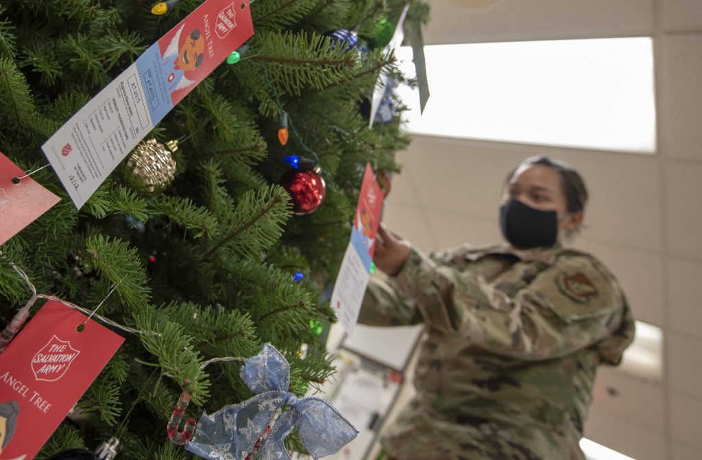 Senior Airman Kathyrn Bayudan, material management specialist with the 154th Logistics Readiness Squadron adjusts ornaments and Angel Tree tags on her unit’s ‘Angel Tree’ Christmas tree, Dec. 5, 2020, Joint Base Pearl Harbor-Hickam. The Angel Tree is a charitable program that collects donations to fulfill christmas wishlists for elderly and children in need. Through the program, Bayudan and fellow LRS Airmen have collected donations to fulfill more than 80 separate christmas wishlists for the Salvation Army sponsored project. (U.S. Air National Guard photo by Staff Sgt. Orlando Corpuz)