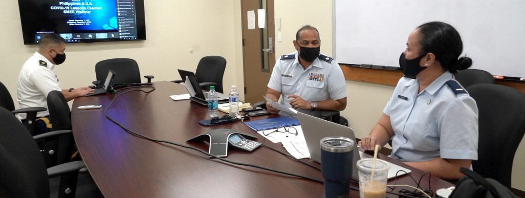 Lt. Col. James Faumuina, 154th Medical Group, Detachment 1 commander and 1st Lt Gloria Choo, International Health Specialist State Partnership Program, discuss the information presented during the COVID-19 subject matter expert exchange between the Armed Forces of the Philippines, and the Guam and Hawaii National Guard, Honolulu, Hawaii, Dec 1, 2020. The SMEE was held virtually due to the on-going pandemic. (U.S. Air National Guard photo by Master Sgt. Andrew Jackson)
