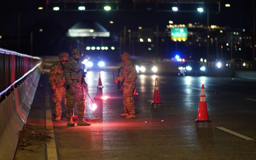 Soldiers with the Hawaii Army National Guard place road flares during traffic security operations on a bridge in Washington, D.C, Jan. 19, 2021. At least 25,000 National Guard men and women have been authorized to conduct security, communication and logistical missions in support of federal and District authorities leading up and through the 59th Presidential Inauguration. (U.S. Air National Guard video by Master Sgt. Andrew Jackson)