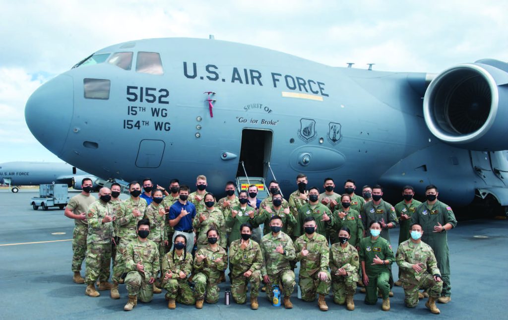 Total-force Airmen who comprise ‘Team Hickam’ and Reserve Officers’ Training Corps cadets gather in front of a C-17 Globemaster III May 25, 2021, at Joint Base Pearl Harbor-Hickam, Hawaii. In observance of Asian American and Pacific Islander Heritage Month, an aircrew from the 204th Airlift Squadron, made up of all-AAPI Airmen, showcased the C-17 to ROTC cadets from the University of Hawaii. AAPI Heritage months celebrates the contributions AAPIs have made to our nation and community. (U.S. Air National Guard photo by Staff Sgt. John Linzmeier)