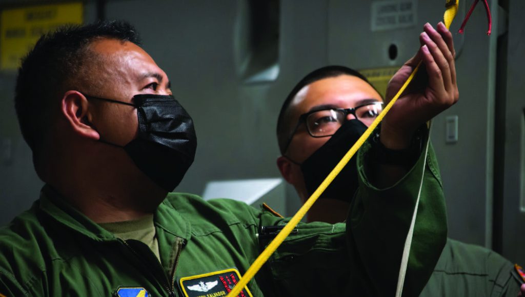 Senior Master Sgt. Joseph Salvador, and Staff Sgt. Justin Lun, 204th Airlift Squadron loadmasters, secure rescue equipment onto a C-17 Globemaster III May 18, 2021, at Moffett Federal Airfield, Calif. (U.S. Air National Guard photo by Staff Sgt. Stefany Leyva)