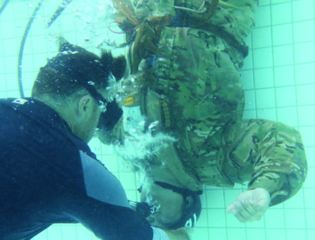 Soldiers of the Hawaii Army National Guard with 3rd Battalion, 126th Aviation Regiment and 1st Battalion, 189th Aviation Regiment participate in the Shallow Water Egress Training (SWET), Kaneohe, Hawaii, June 10, 2021. Soldiers use this to prepare themselves for Helicopter Over-Water Survival Training (HOST). (U.S. Army National Guard photo by Spc. Mariah-Alexsandra Manandic-Kapu)