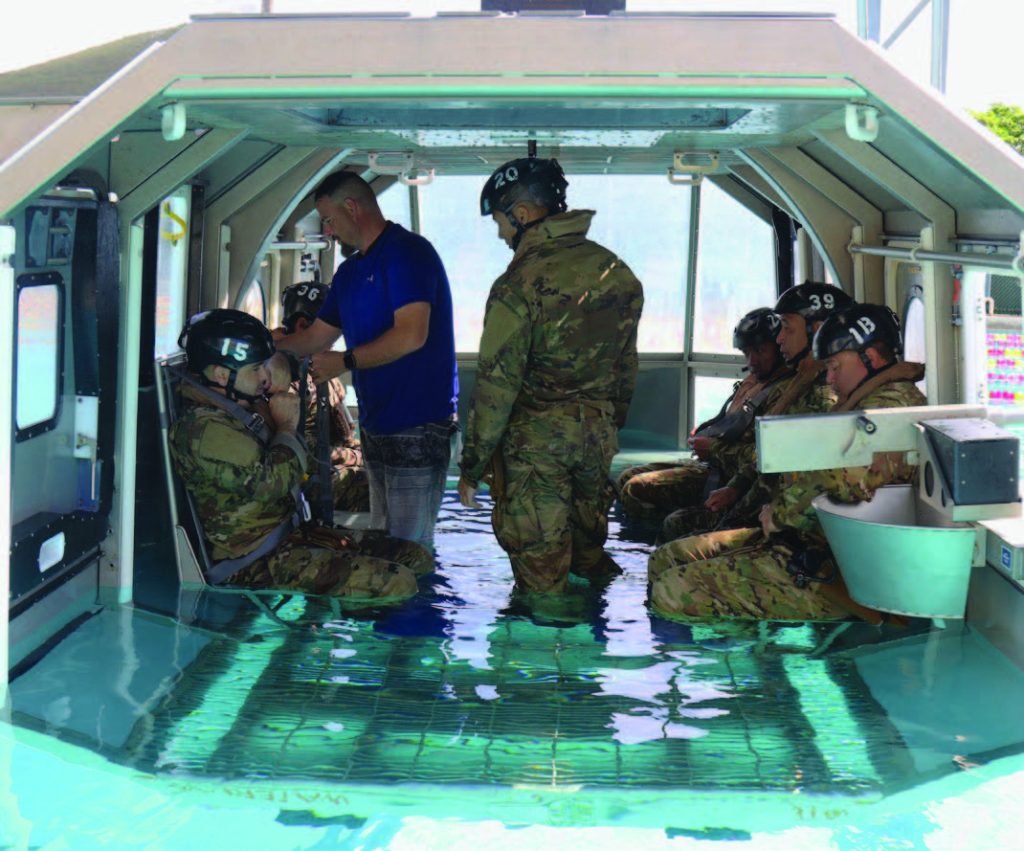 Soldiers of the Hawaii Army National Guard with 3rd Battalion, 126th Aviation Regiment and 1st Battalion, 189th Aviation Regiment participate in the Shallow Water Egress Training (SWET), Kaneohe, Hawaii, June 10, 2021. Soldiers use this to prepare themselves for Helicopter Over-Water Survival Training (HOST). (U.S. Army National Guard photo by Spc. Mariah-Alexsandra Manandic-Kapu)