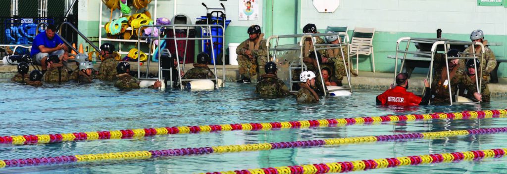 Soldiers of the Hawaii Army National Guard with 3rd Battalion, 126th Aviation Regiment and 1st Battalion, 189th Aviation Regiment participate in the Shallow Water Egress Training (SWET), Kaneohe, Hawaii, June 10, 2021. Soldiers use this to prepare themselves for Helicopter Over-Water Survival Training (HOST). (U.S. Army National Guard photo by Spc. Mariah-Alexsandra Manandic-Kapu)
