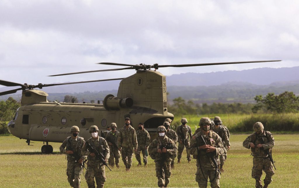 Hawaii Army National Guard (HIARNG) and Hawaii Army Reserve Soldiers exit the CH-47 Chinook at the conclusion of the land navigation event during the Best Warrior Competition (BWC), Schofield Barracks, Hawaii, March 6, 2021. The BWC is a three-day annual competition where Soldiers are tested to earn the title of teh “Best Warrior” through many challenges including fi ring weapons, land navigation, a physical fitness test and various mystery events. (U.S. Army National Guard photo by Spc. Mariah-Alexsandra K. Manandic-Kapu)