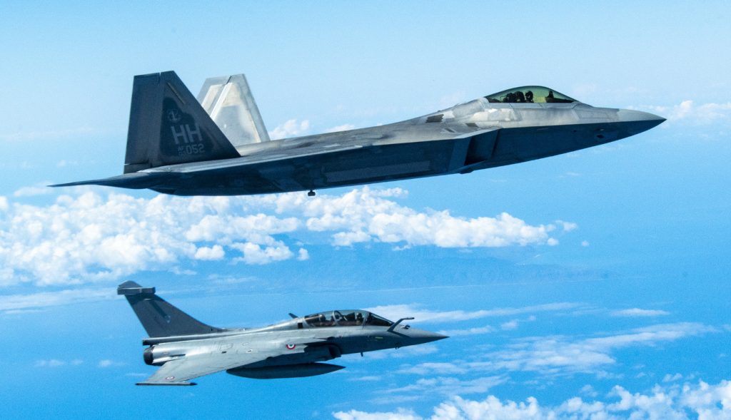 A Hawaii Air National Guard F-22 Raptor flies in formation with a French Air and Space Force F3-R Rafale June 30, 2021, near Oahu, Hawaii. FASF aircraft, maintenance, and support personnel traveled to Hawaii for exercise Wakea, as part of the bilateral cooperation in the Pacific between the United States and France. During Wakea, Hawaii ANG F-22 Raptors trained with FASF aircraft to enhance air-combat expertise and interoperability between the two countries’ aircraft. In a unique association, the F-22s and the air defense mission at Joint Base Pearl Harbor-Hickam are assigned to the 154th Wing, Hawaii Air National Guard. Collectively known as the Hawaiian Raptors, the Hawaii ANG 199th Fighter Squadron and active duty 19th Fighter Squadron serve together under the Air National Guard-led active-associate construct to execute their mission sets. (U.S. Air National Guard photo by Staff Sgt. Orlando Corpuz)