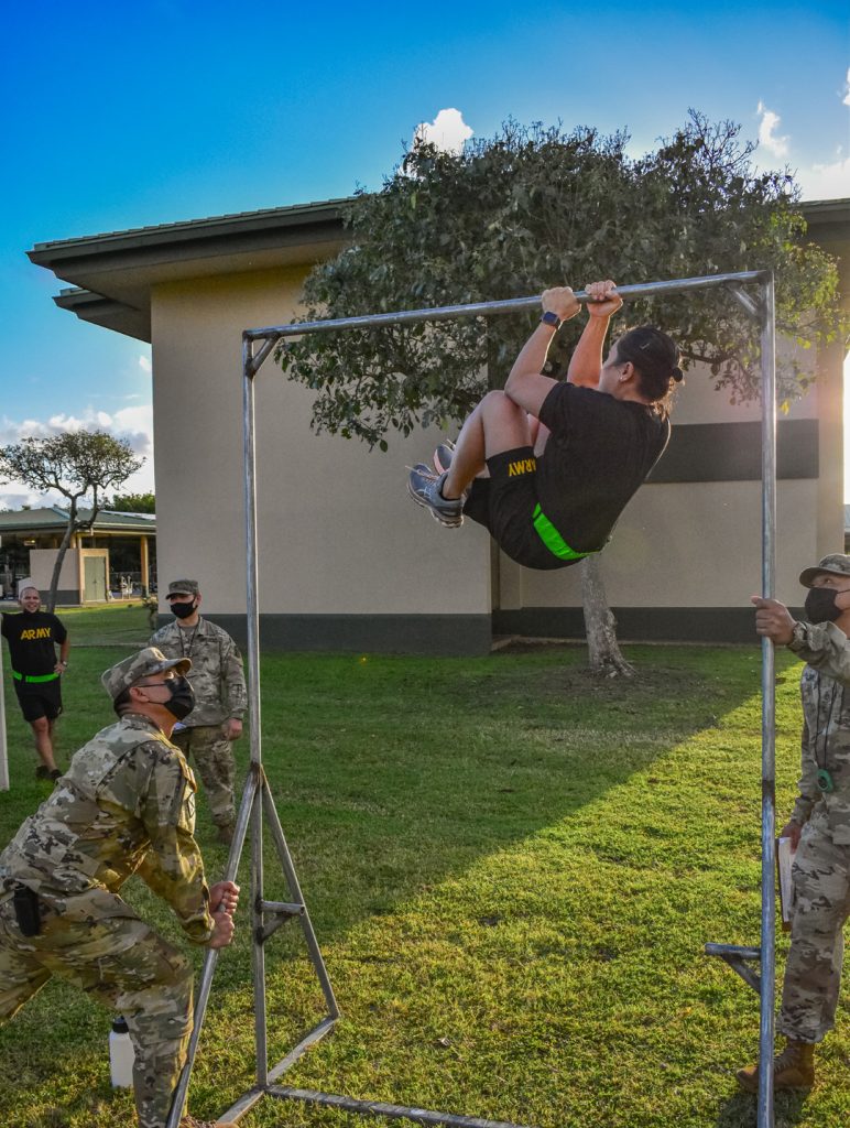 Hawaii Army National Guard Soldier, Staff Sgt. Charifel Mateo, a Musician with the 111th Army Band, 103rd Troop Command performs the leg tuck (LTK) event during the Army Combat Fitness Test, Waimanalo, Hawaii, April 2, 2021. The LTK measures upper and lower body explosive power, flexibility, and dynamic balance assisting with tasks like a buddy drag, throwing a hand grenade and employing progressive levels of force in man-to-man contact.