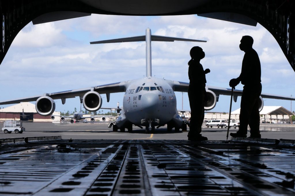 Master Sgt. Joleen Morse and Tech. Sgt. Cory Okimura, 204th Airlift Squadron loadmasters, prepare a C-17 Globemaster III for flight Sept. 4, 2021, at Joint Base Pearl Harbor Hickam-Hawaii. A team of aircraft maintenance personnel and aircrew flew to California to conduct astronaut rescue training with partners in Moffett Federal Airfield. (U.S. Air National Guard photo by Staff Sgt. John Linzmeier