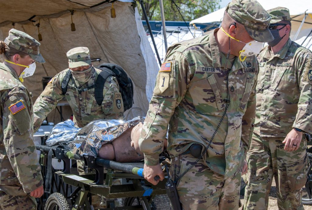California Army National Guard Soldiers with the 95th Civil Support Team transport a simulated victim of a notional radiological explosion on a stretcher during exercise Sentinel Response 2021 in Concord, Calif., April 16, 2021. Sentinel Response 2021 is a full scale exercise that provides local and state first responders and elements of the California Army and Air National Guard with the opportunity to conduct Urban Search and Rescue Operations in a simulated radioactively contaminated environment. (U.S. Air National Guard photo by Staff Sgt. Orlando Corpuz)
