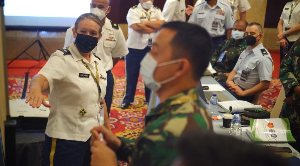 Lt. Col. Katherine Kalama, Hawaii Army National Guard, and a team of military planners from the Tentara Nasional Indonesia (TNI) and the Hawaii National Guard discuss the center of gravity assessments for the exercise scenario during the operational design workshop of Exercise GEMA BHAKTI, Sept 18, 2021, Jakarta Indonesia. The operational design workshop in the precursor exercise for Exercise GEMA BHAKTI and is facilitated by the Hawaii National Guard with the Tentara Nasional Indonesia (TNI) as a part of the State Partnership Program. (U.S. Air National Guard photo by Master Sgt. Andrew Jackson)