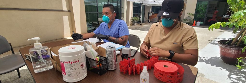 Sgt. Ryan Langas and Spc. Kadie Hoopai, medics with the Hawaii National Guard Joint Task Force, Task Force Medical prepare to receive and register members of the community for COVID-19 testing on August 25, 2021, at the Honolulu Police Department’s Chinatown Substation. A team of medical specialists conducted more than 1,400 COVID tests in the Chinatown historic district in Honolulu. (U.S. Army National Guard photo by 1st Lt. Anyah Peatross)