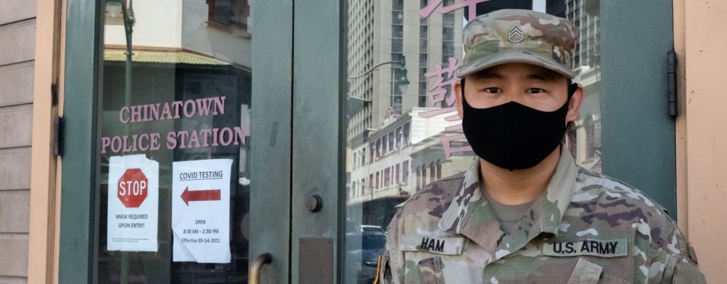 Staff Sgt. William Ham, an Army medic from the Hawaii National Guard Joint Task Force, Task Force Medical poses in front of the Honolulu Police Department’s Chinatown Substation in Honolulu, Hawaii, September 28, 2021. For more than two months, Ham and his team of medical specialists offered free rapid COVID testing in the historic Chinatown district. (U.S. Army National Guard photo by 1st Lt. Anyah Peatross)