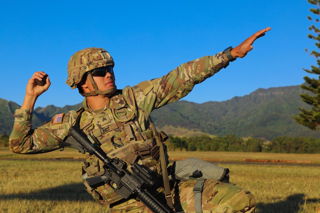 Hawai‘i Army National Guard (HIARNG) Soldier, Sgt. Fred M. Lino Jr., a small arms and artillery repairer, assigned to Echo Troop, Forward Support Company (FSC), 227th Brigade Engineer Battalion (BEB), simulates throwing a grenade at Area X, Schofield Barracks, Hawai‘i, March 6, 2022. Grenade throwing was the mystery event in the Expert Soldier Badge (ESB) tasks event for the annual Best Warrior Competition (BWC). (U.S. Army National Guard photo by Sgt. Lianne M. Hirano)