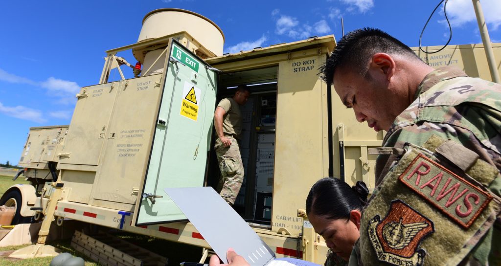 U.S. Air Force Airmen from the 297th Air Traffic Control Squadron go over checklists prior to the operation of a Tactical Air Navigation System, Mar. 3, 2022, at Marine Corps Base Kaneohe, HI as part of Agile Combat Employment exercise Hoʻo Ikaika. ACE is an operational concept that leverages networks of well-established and austere air bases, multi-capable Airmen, pre-positioned equipment, and airlift to rapidly deploy, disperse and maneuver combat capability throughout a theater. (U.S. Air National Guard photo by Staff Sgt. Orlando Corpuz)