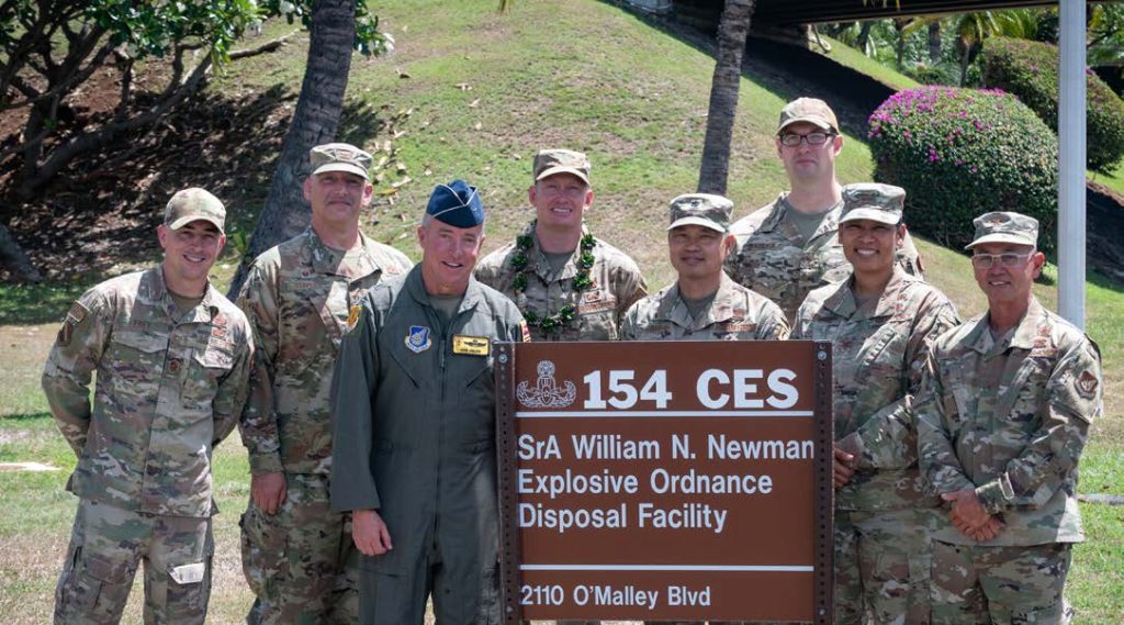 Leadership from the Hawai‘i Air National Guard and 154th Wing join original members of the 154th Civil Engineer Squadron’s Explosive Ordnance Disposal Flight during an EOD Standup Ceremony May 31, 2022, at Joint Base Pearl Harbor-Hickam, Hawaii. The EOD flight was previously designated as the 647th EOD flight from 1992 to 2022 and transitioned into a Hawai‘i Air National Guard asset under the 154th Wing The facility is named in honor of Senior Airman William N. Newman, who was the second, Hickam-based EOD Airman who was killed in action. (U.S. Air National Guard photo by Staff Sgt. John Linzmeier)