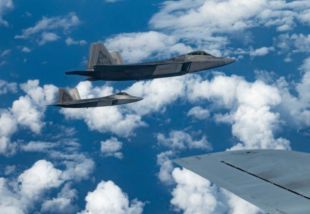 The inbound and outbound commanders of the 154th Wing fly F-22 Raptors in formation with a KC-135 Stratotanker Sept. 7, 2022, near Oahu, Hawaii. The routine training flight served as an in-flight change of command ceremony as Brig. Gen. Dann S. Carlson relinquished command of the Air National Guard’s largest Wing to Col. Phillip L. Mallory. (U.S. Air National Guard photo by Tech. Sgt. Nicholas Brown)