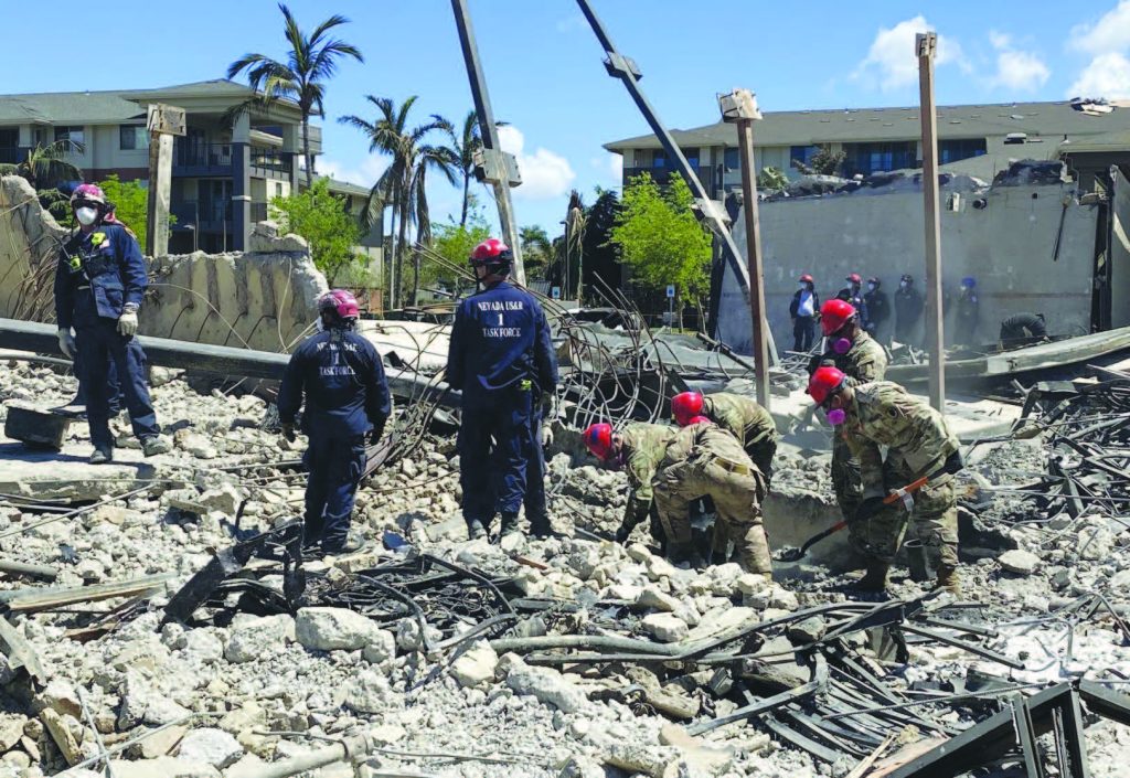 Search and Extraction Element and Federal Emergency Management Agency Urban Search & Rescue search through debris after the Aug. 8 Maui wildfire. – Hawai‘i National Guard photo