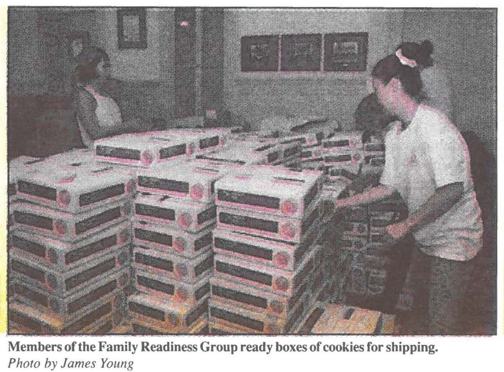 Members of the Family Readiness Group ready boxes of cookies for shipping. Photo by James Young