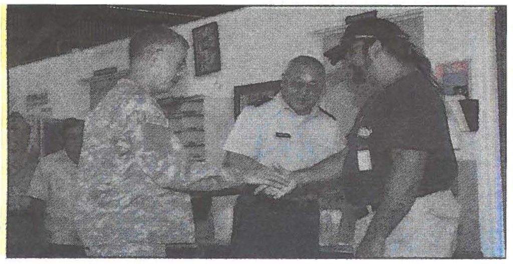 BELOW LEFT -Maj. Gen. Robert G.F. Lee thanks Eddie Tangonan with a hand shake for his efforts supporting the troops.