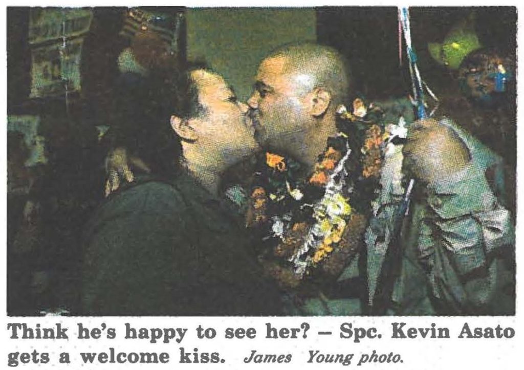 Think he's happy to see her? - Spc. Kevin Asato gets a welcome kiss. James Young photo.