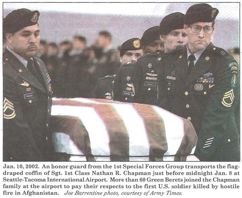 Jan. 10, 2002. An honor guard from the 1st Special Forces Group transports the flag-draped coffin of Sgt. 1st Class Nathan R. Chapman just before midnight Jan. 8 at Seattle-Tacoma International Airport. More than 60 Green Berets joined the Chapman family at the airport to pay their respects to the first U.S. soldier killed by hostile fire in Afghanistan. Joe Barrentine photo, courtesy of Army Times.