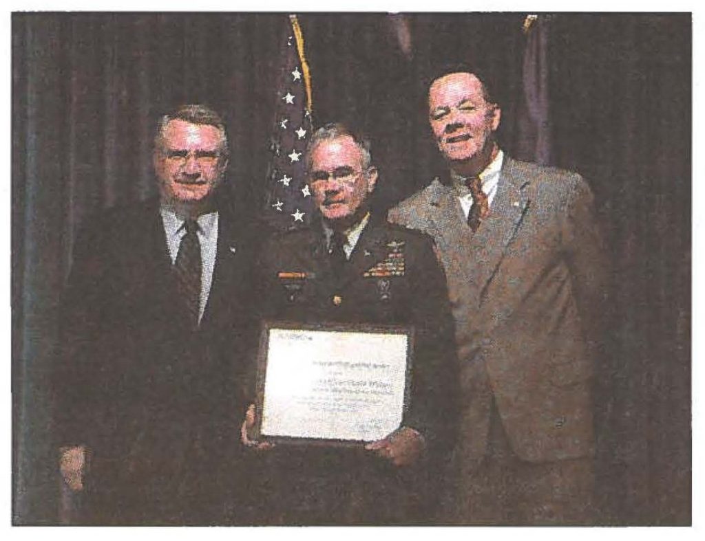 John Walters, Director of the Office of National Drug Control Policy, ChiefWarrant Officer Dave Watters, and Scott Burns, deputy director for State and local affairs for ONDCP pose with Chief Watters's Director's Award for Distinguished Service. Staff Sgt. Cheryl Hackley, National Guard Bureau, photo