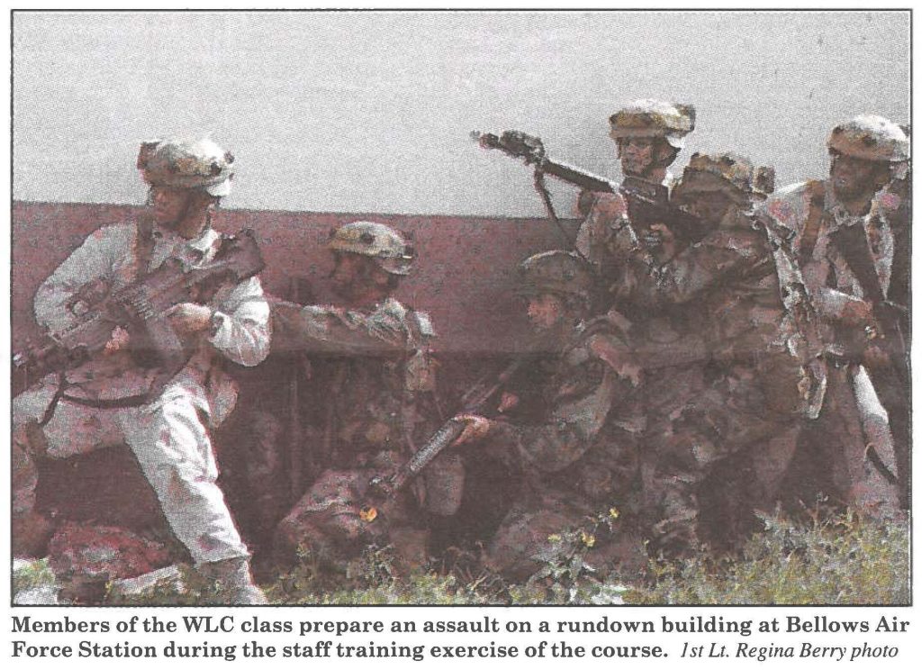 Members of the WLC class prepare an assault on a rundown building at Bellows Air Force Station during the staff training exercise of the course. 1st Lt. Regina Berry photo