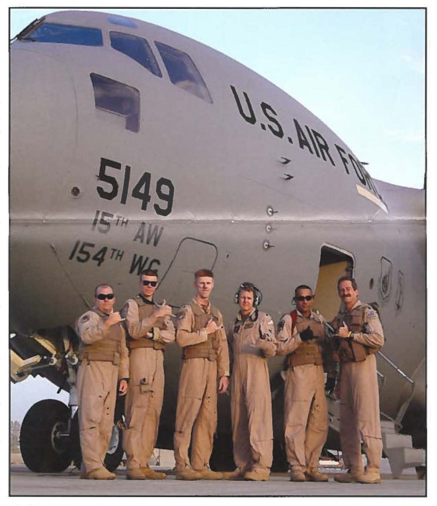 Hawaii Air National Guard aircrew pose with their C-17 Globemaster aircraft on the runway.