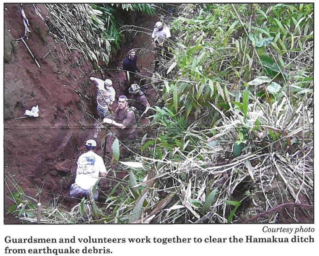 Guardsmen and volunteers work together to clear the Hamakua ditch from earthquake debris.