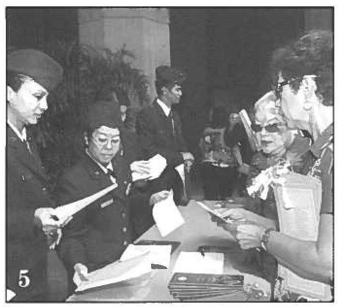 Hawaii Air National Guard Airmen pass out programs.