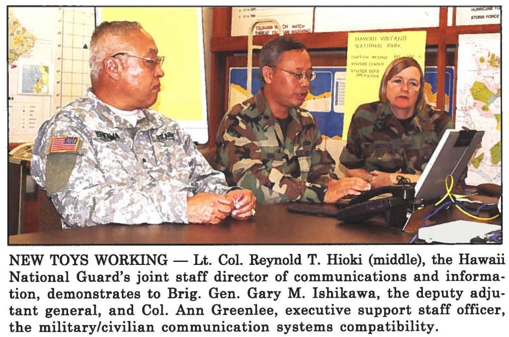 NEW TOYS WORKING - Lt. Col. Reynold T. Hioki (middle), the Hawaii National Guard's joint staff director of communications and information, demonstrates to Brig. Gen. Gary M. Ishikawa, the deputy adjutant general, and Col. Ann Greenlee, executive support staff officer, the military/civilian communication systems compatibility.