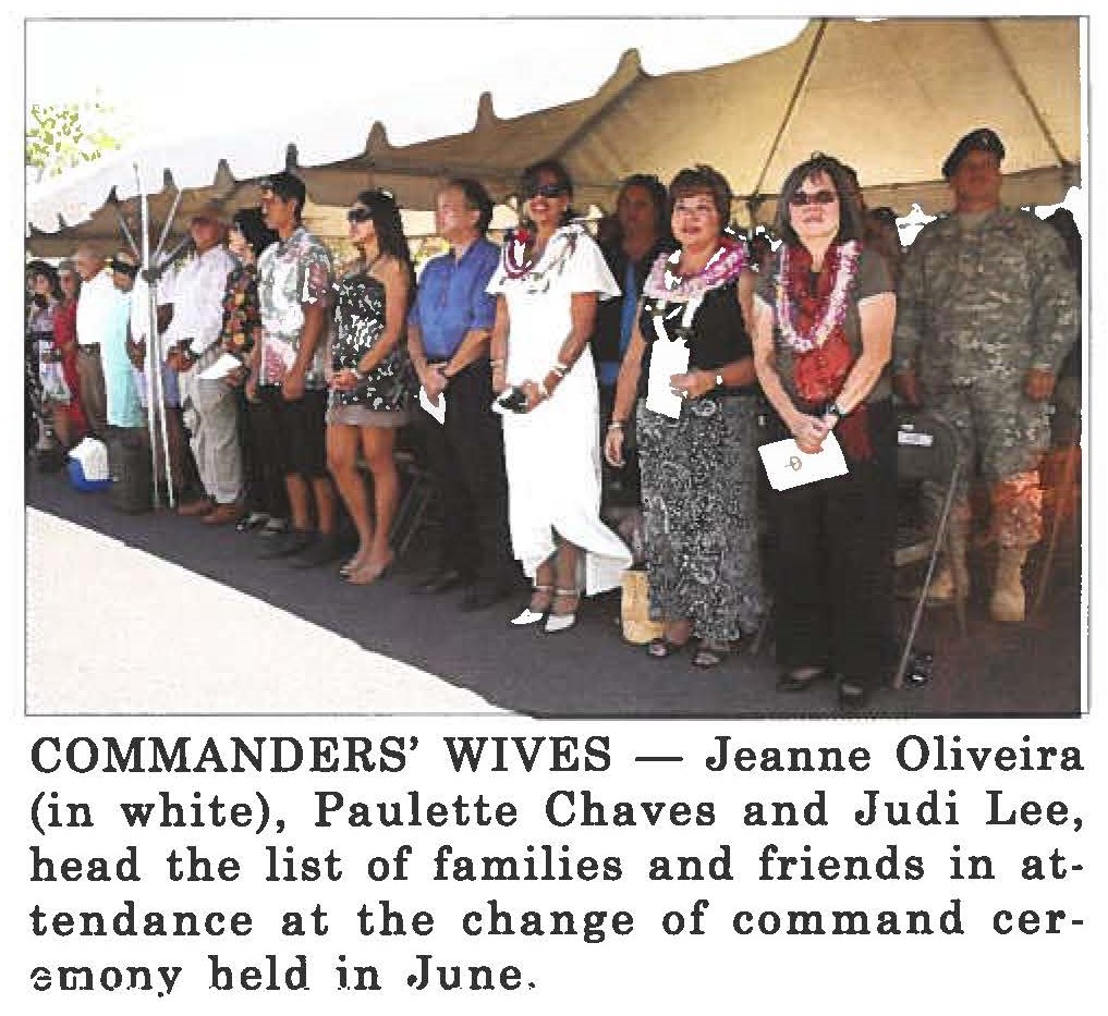 COMMANDERS' WIVES - Jeanne Oliveira (in white), Paulette Chaves and Judi Lee, head the list of families and friends in attendance at the change of command ceremony held in June.