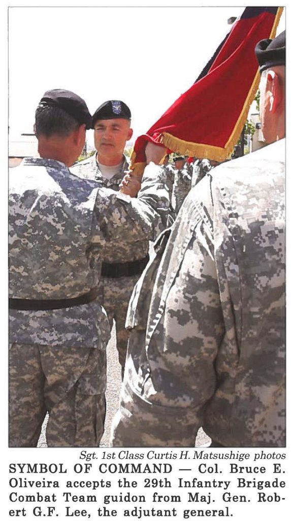 SYMBOL OF COMMAND - Col. Bruce E. Oliveira accepts the 29th Infantry Brigade Combat Team guidon from Maj. Gen. Robert G.F. Lee, the adjutant general.