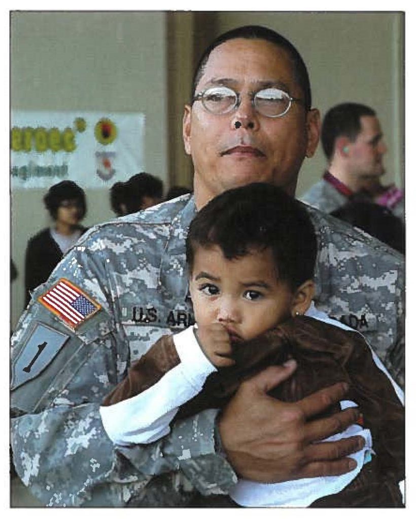 JUST VISITING - Staff Sgt. Alan B. Allosada, a helicopter fuel handler, carries his 2-year-old grandson, C.J. Tadiarca-Warner, before leaving on his third tour of duty with the Hawaii Army National Guard in Iraq.