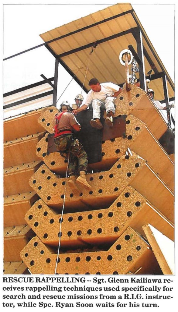 RESCUE RAPPELLING -- Sgt. Glenn Kailiawa receives rappelling techniques used specifically for search and rescue missions from a R.I.G. instructor, while Spc. Ryan Soon waits for his turn.