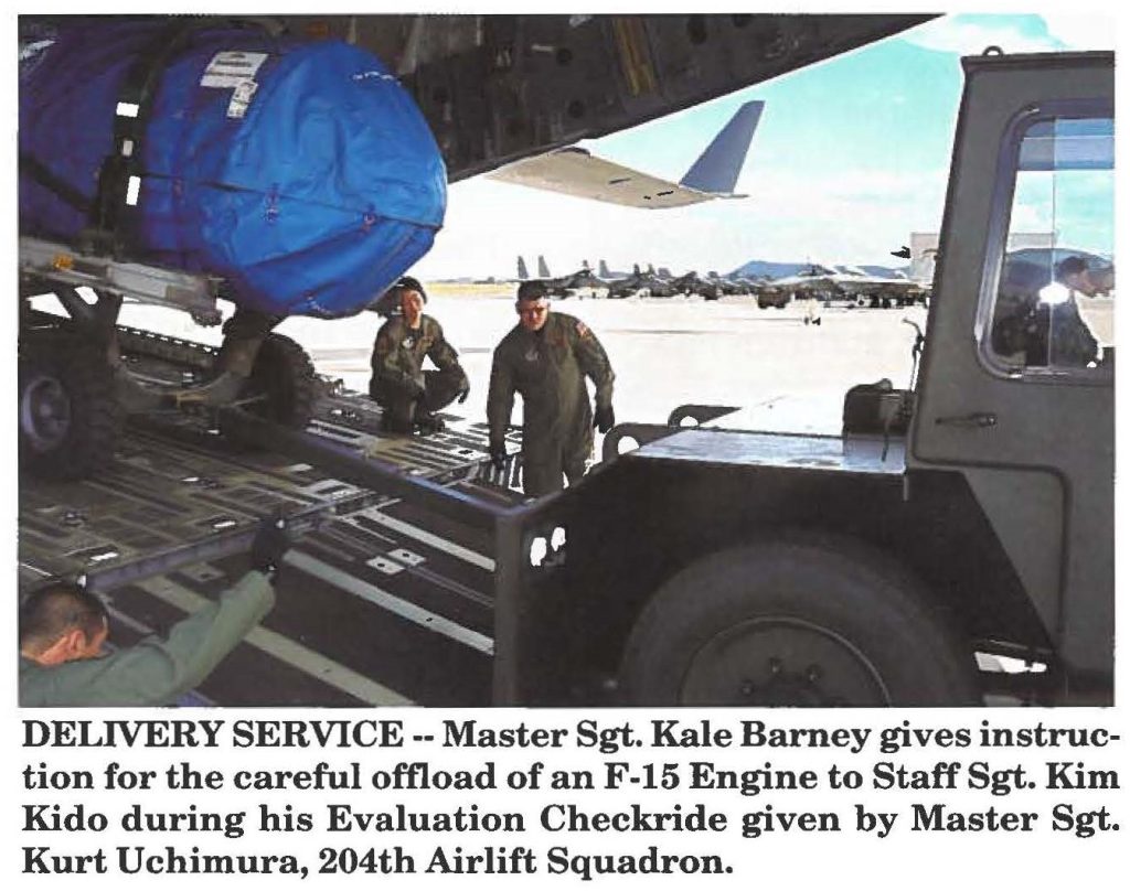 DELIVERY SERVICE -- Master Sgt. Kale Barney gives instruction for the careful offload of an F-15 Engine to Staff Sgt. Kim Kido during his Evaluation Checkride given by Master Sgt. Kurt Uchimura, 204th Airlift Squadron.
