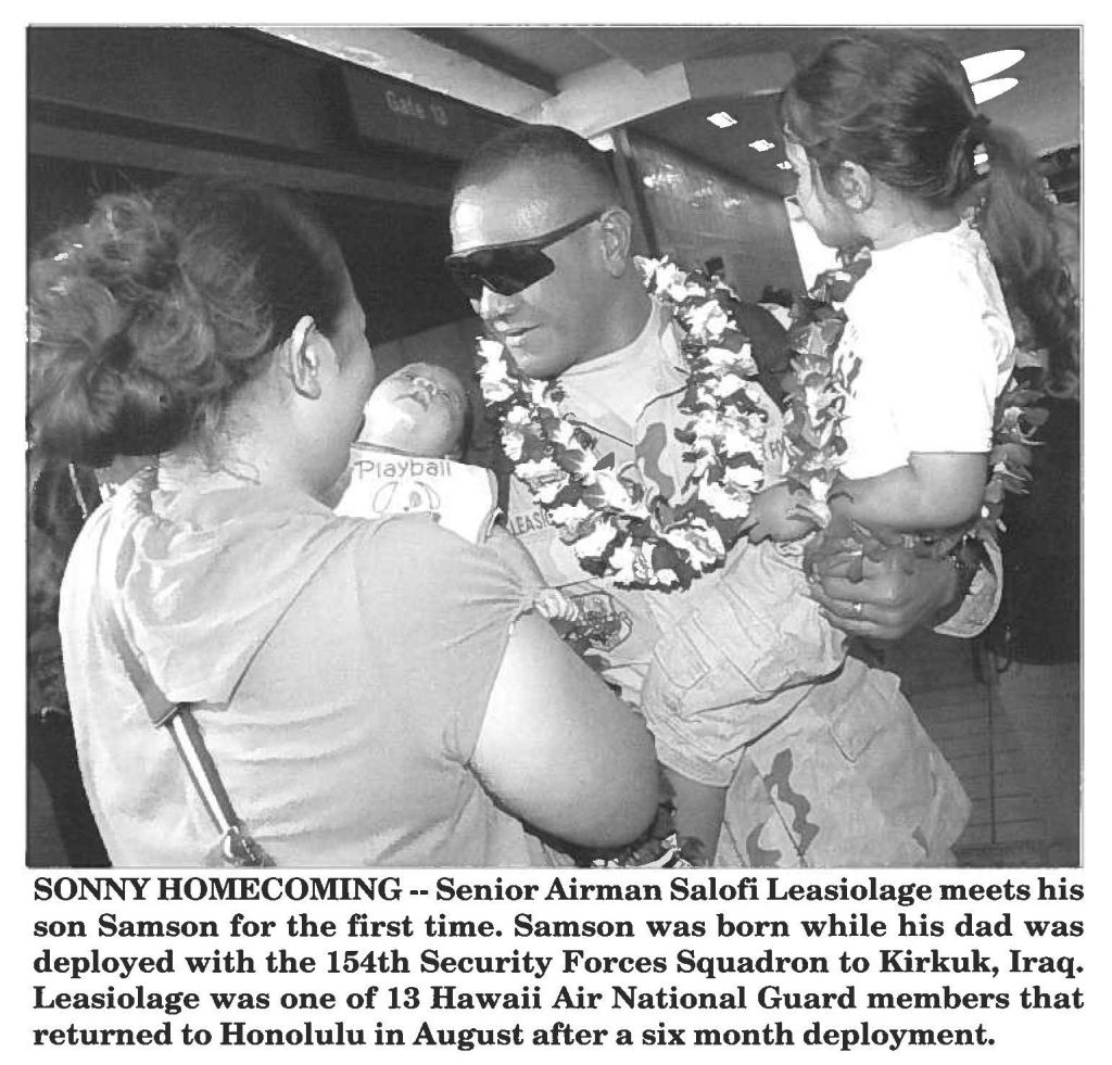 SONNY HOMECOMING -- Senior Airman Salofi Leasiolage meets his son Samson for the first time. Samson was born while his dad was deployed with the 154th Security Forces Squadron to Kirkuk, Iraq. Leasiolage was one of 13 Hawaii Air National Guard members that returned to Honolulu in August after a six month deployment.