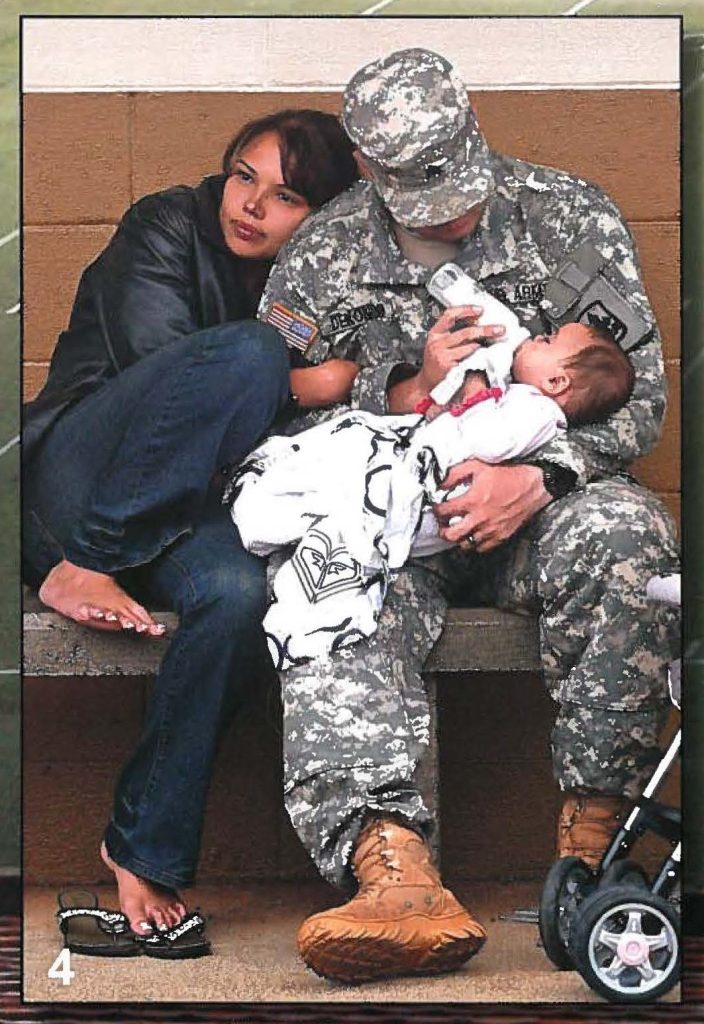 Sgt. Captain Deoning feeds his 6-month-old daughter, Rmi, while his wife, Anela, holds on tight.