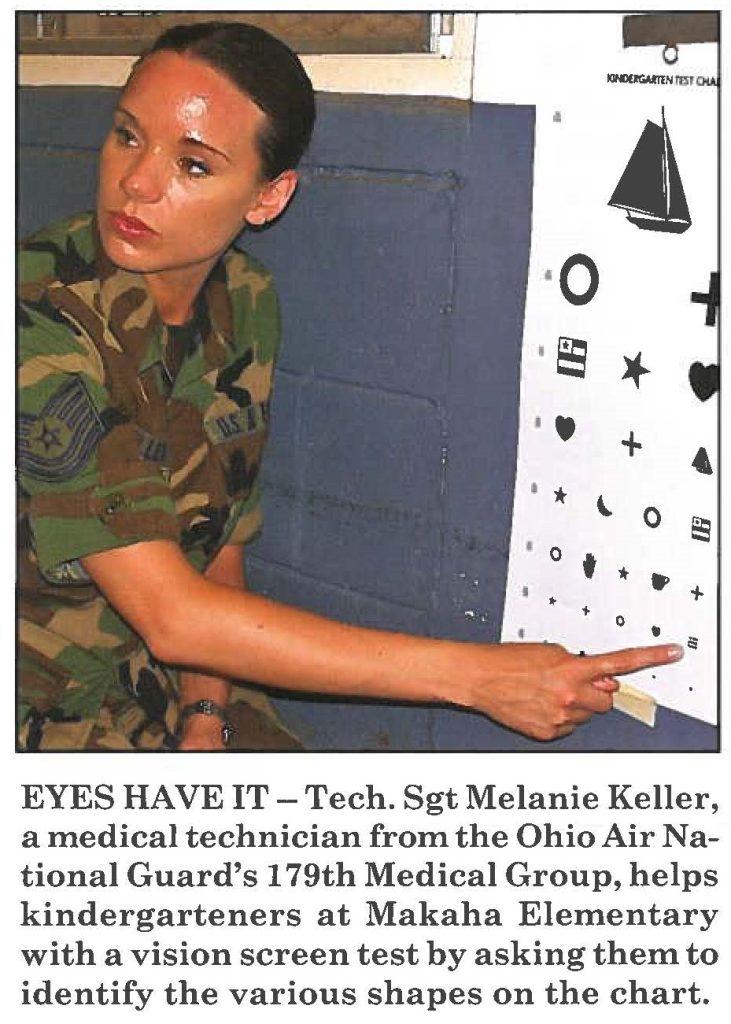 EYES HAVE IT - Tech. Sgt Melanie Keller, a medical technician from the Ohio Air National Guard's 179th Medical Group, helps kindergarteners at Makaha Elementary with a vision screen test by asking them to identify the various shapes on the chart.